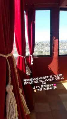 a red curtain in a room with two windows at Lucerito no reserve x aca in Villa Santa Cruz del Lago