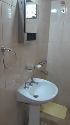 a bathroom with a white sink and a mirror at Complejo de cabañas el Winon in Cuesta Blanca