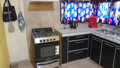 a kitchen with a stove and a sink at Complejo de cabañas el Winon in Cuesta Blanca