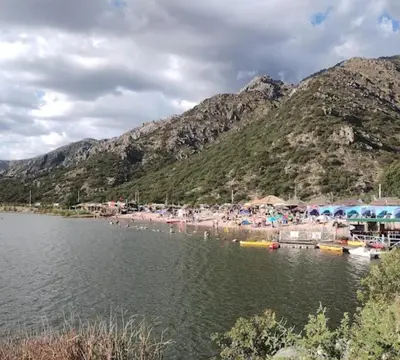 a group of people on a beach near a body of water at Cabañas Lumel in Carpintería