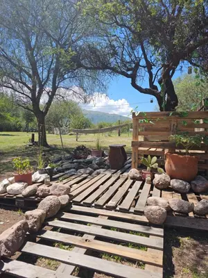 a garden with rocks and a wooden pathway at Cabañas Lumel in Carpintería