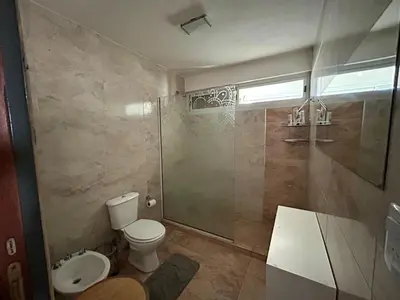a bathroom with a toilet and a shower and a sink at Casita verde in Villa Santa Cruz del Lago