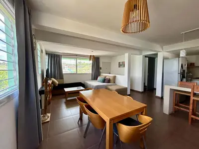 a living room with a table and a couch at Casita verde in Villa Santa Cruz del Lago