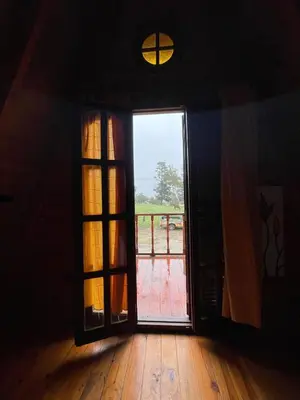 an open door with a view of a deck at Cerro del Alma in Villa Yacanto