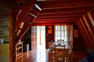 a dining room with a table and chairs in a house at Cerro del Alma in Villa Yacanto