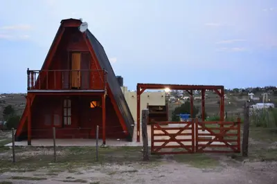 a small house with a gate and a barn at Cerro del Alma in Villa Yacanto