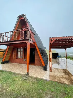 a house with a roof on top of a yard at Cerro del Alma in Villa Yacanto