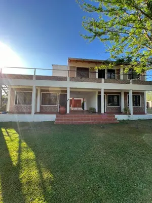 a large brick house with a large yard at El Rincon Verde in Bialet Massé