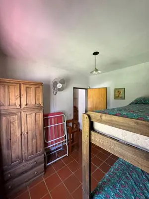 a bedroom with a bed and a dresser in it at El Rincon Verde in Bialet Massé