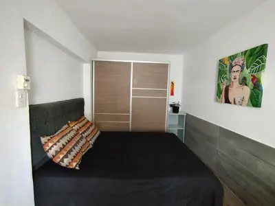 a bedroom with a bed with a black blanket at DepartamentoVCP in Villa Carlos Paz