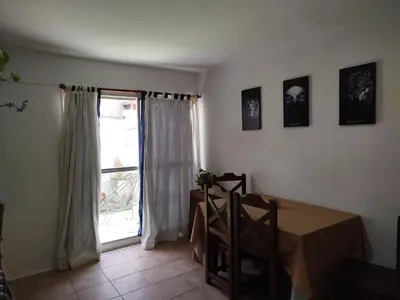 a dining room with a table and a window at DepartamentoVCP in Villa Carlos Paz