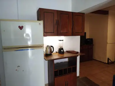 a kitchen with a white refrigerator and a counter at DepartamentoVCP in Villa Carlos Paz