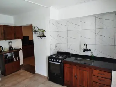 a kitchen with a black stove and a sink at DepartamentoVCP in Villa Carlos Paz