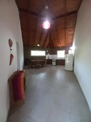a large room with a room with tables and a light at Tantanakuy 3 in Villa General Belgrano