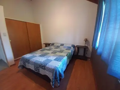 a bedroom with a bed with a quilt on it at Tantanakuy 3 in Villa General Belgrano