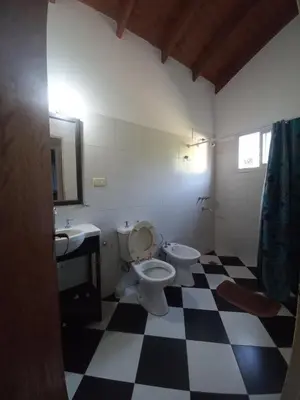 a bathroom with a toilet and a sink at Tantanakuy 3 in Villa General Belgrano