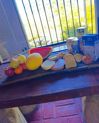 a table with different types of food on it at Cabañas TUPAC LIHUE in Arroyo de Los Patos