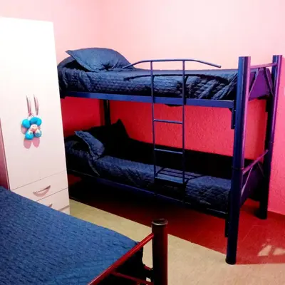 a room with two bunk beds and a table at Brisas de las Sierras in Tanti