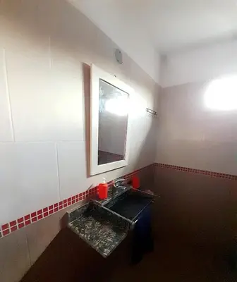 a bathroom with a sink and a mirror at Brisas de las Sierras in Tanti