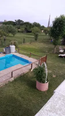 a swimming pool in a yard with a potted plant at Lucrecia in Villa Parque Siquiman