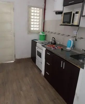 a small kitchen with a stove and a sink at Lucrecia in Villa Parque Siquiman