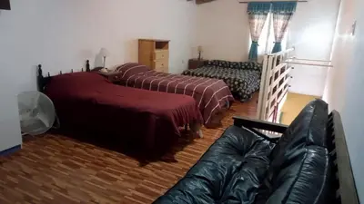 a living room with two beds and a couch at Lucrecia in Villa Parque Siquiman
