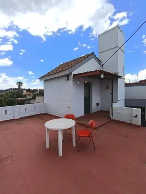 a white table and two chairs on a patio at Cielo Serrano VCP in Villa Carlos Paz