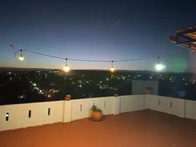 a view of a rooftop at night with lights at Cielo Serrano VCP in Villa Carlos Paz