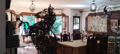 a dining room with a table and a room with chairs at maemm el castillto in Mina Clavero