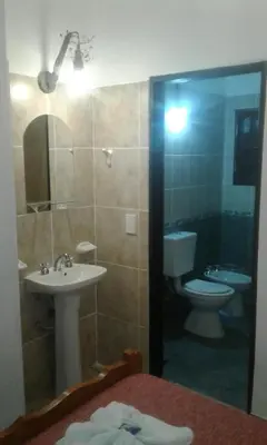 a bathroom with a sink and a toilet and a mirror at maemm el castillto in Mina Clavero