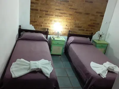 two beds with bows on them in a room at maemm el castillto in Mina Clavero