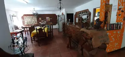 a restaurant with a table and chairs and a brick wall at maemm el castillto in Mina Clavero