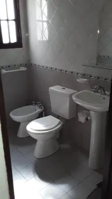 a white bathroom with a toilet and a sink at maemm el castillto in Mina Clavero