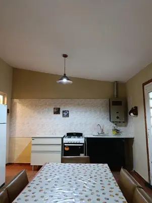 a kitchen with a table and a stove top oven at Casa en centro de Icho Cruz in Villa Icho Cruz