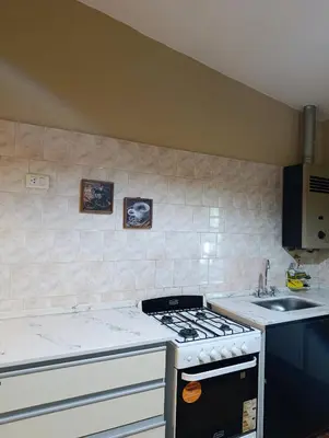 a kitchen with a stove and a sink at Casa en centro de Icho Cruz in Villa Icho Cruz