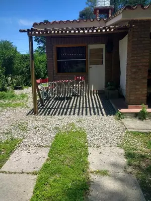 a house with a patio with a table and chairs at Fermina in Villa Icho Cruz