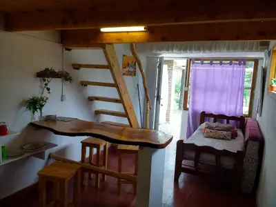 a room with a spiral staircase in a house at Fermina in Villa Icho Cruz