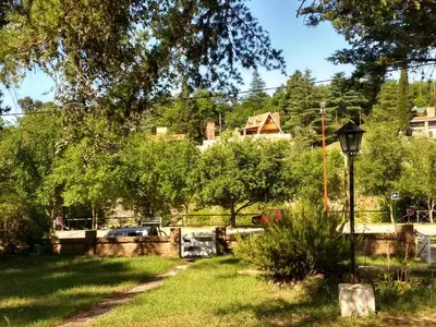 a park with a street light in the grass at Fermina in Villa Icho Cruz