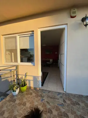 an open door of a house with a patio at El Paraiso in Villa Carlos Paz