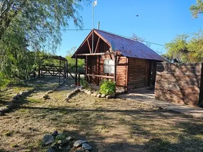 a small wooden cabin with a red roof at Cabañas Lumel in Carpintería