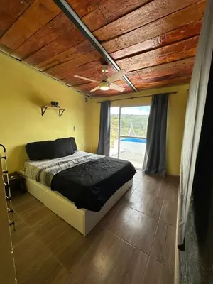 a bedroom with a bed and a wooden ceiling at ecolodge in San Pedro