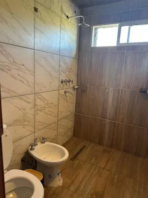 a bathroom with a toilet and a sink and a shower at ecolodge in San Pedro