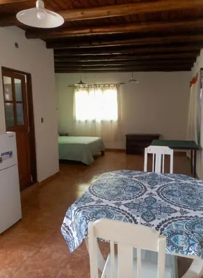 a room with a table and two chairs and a bed at Cabaña para 2 Personas en Arroyo de los patos in Arroyo de Los Patos