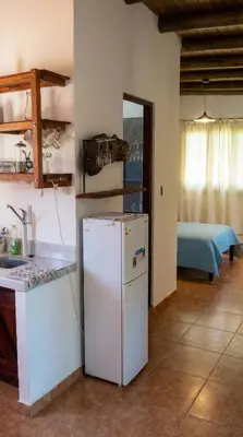 a kitchen with a white refrigerator in a room at Cabaña para 2 Personas en Arroyo de los patos in Arroyo de Los Patos