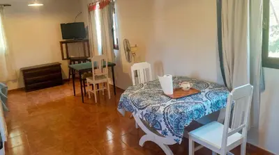 a small room with a table and chairs and a television at Cabaña para 2 Personas en Arroyo de los patos in Arroyo de Los Patos