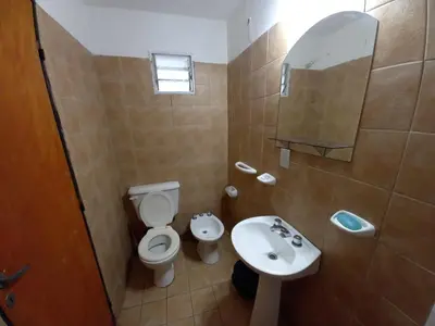 a bathroom with a toilet and a sink at Departamento 1 Doña Victoria in Villa Carlos Paz