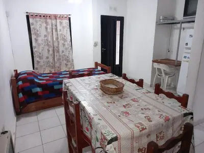a kitchen with a table and chairs with a table at Departamento 1 Doña Victoria in Villa Carlos Paz