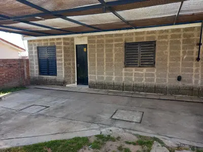 an empty parking lot in front of a brick building at Departamento 1 Doña Victoria in Villa Carlos Paz