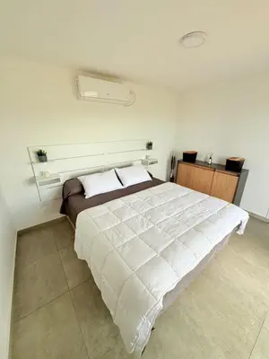 a bedroom with a large white bed in a room at MontSelah Casa en la montaña con pileta para 2 in Tanti
