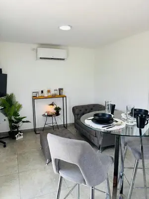 a living room with a table and a couch at MontSelah Casa en la montaña con pileta para 2 in Tanti